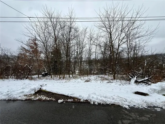 a view of snow on the side of a road