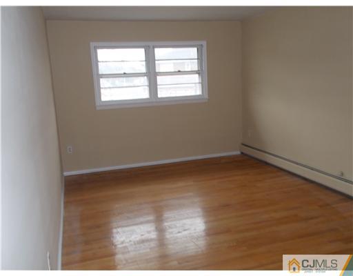 4 Wren Court Edison, NJ 08820 - Photo 14 of 16 an empty room with wooden floor