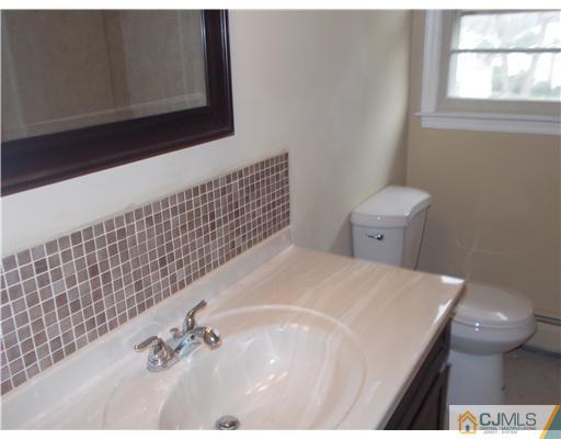 4 Wren Court Edison, NJ 08820 - Photo 15 of 16 a bathroom with a sink and a toilet
