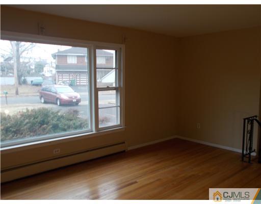 4 Wren Court Edison, NJ 08820 - Photo 7 of 16 a view of a small space with wooden floor and a window