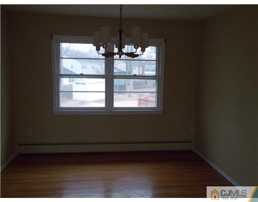 4 Wren Court Edison, NJ 08820 - Photo 8 of 16 a view of empty room with wooden floor and fan
