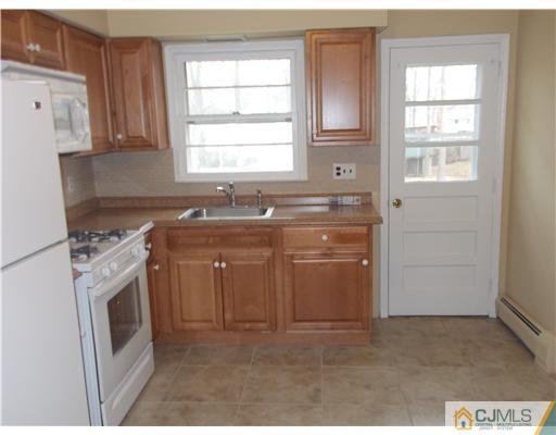 4 Wren Court Edison, NJ 08820 - Photo 9 of 16 a utility room with granite countertop a sink a washer and dryer