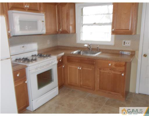 4 Wren Court Edison, NJ 08820 - Photo 10 of 16 a kitchen with a stove and a sink