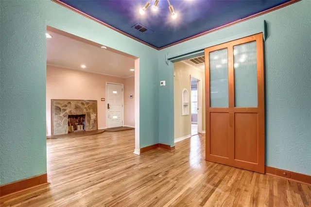 a view of a hallway with wooden floor and a fireplace