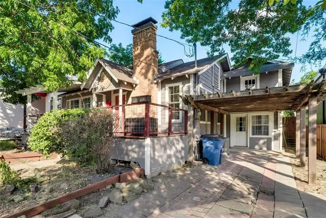 a view of a house with backyard and sitting area