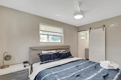 a bedroom with a bed and a window