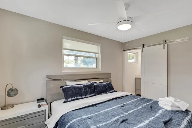 a bedroom with a bed and a window