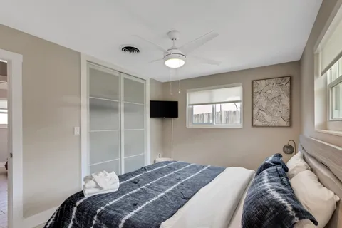 a bedroom with a bed and a window