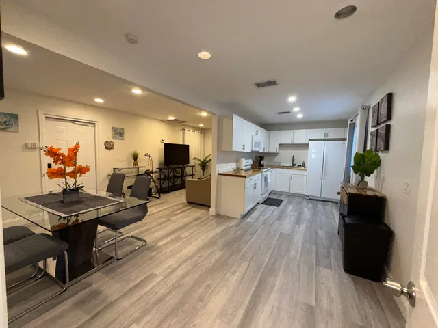 a bathroom with a sink a toilet a mirror and shower