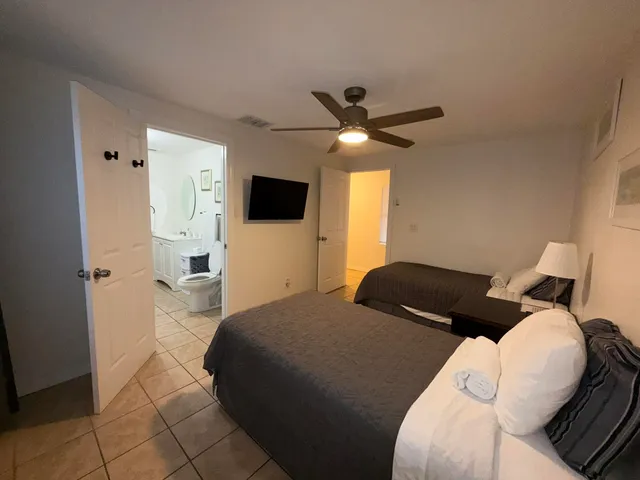 a view of a hallway with wooden floor and a living room