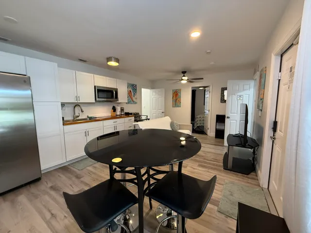 a kitchen with stainless steel appliances a sink and a refrigerator