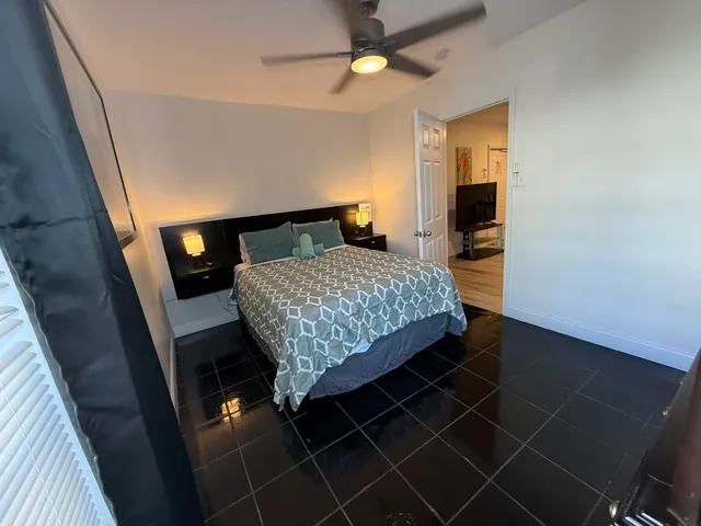 a spacious bedroom with a bed and a window