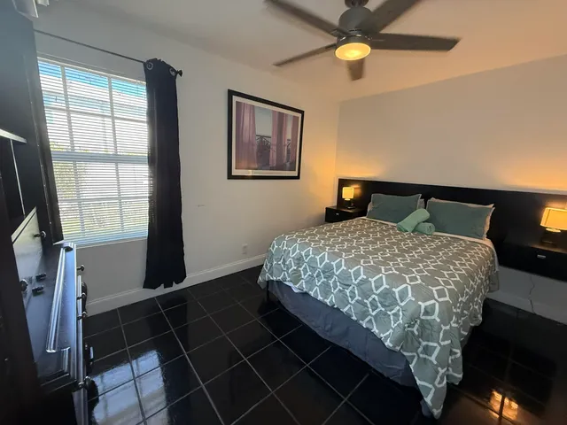 a bed room with a bed mirror and a window