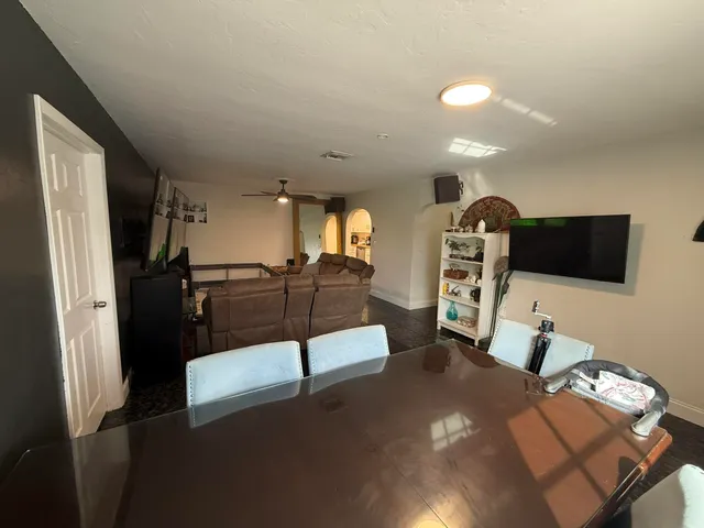 a view of a livingroom with furniture and a flat screen tv