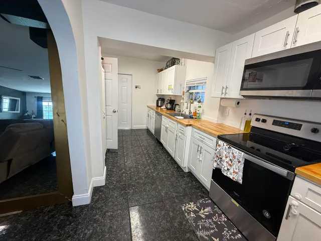 a view of backyard with outdoor seating and plants