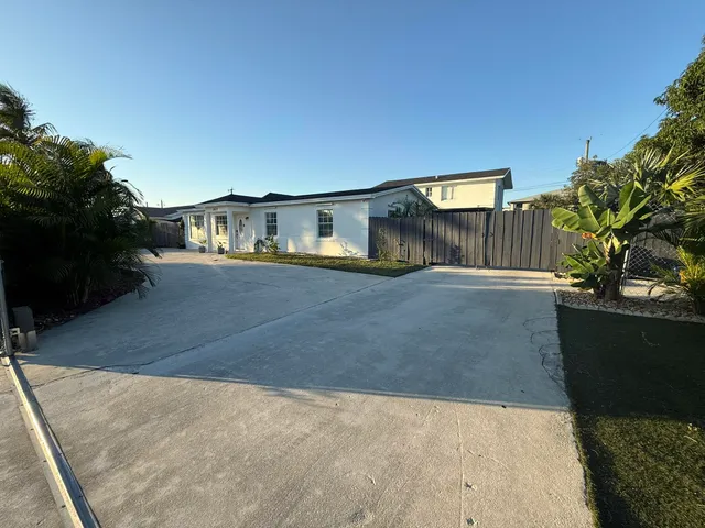 an aerial view of residential houses with outdoor space and street view