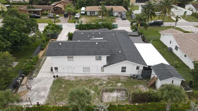 a living room with lots of furniture and kitchen view