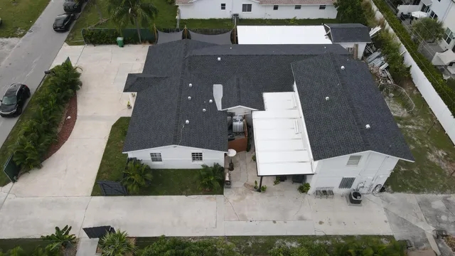 a living room with stainless steel appliances kitchen island granite countertop furniture wooden floor and a view of kitchen