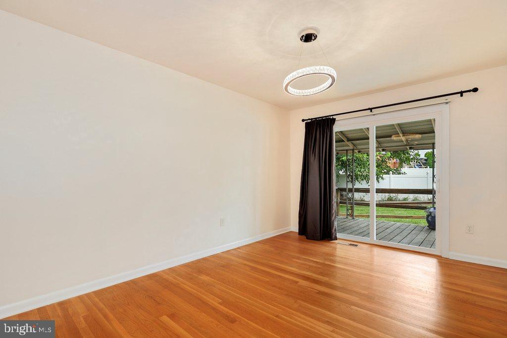 8538 Brest Road Randallstown, MD 21133 - Photo 12 of 47 a view of an empty room with wooden floor and a window