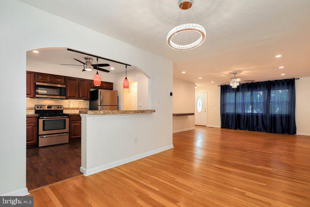 8538 Brest Road Randallstown, MD 21133 - Photo 14 of 47 a kitchen with stainless steel appliances granite countertop a refrigerator and a stove top oven