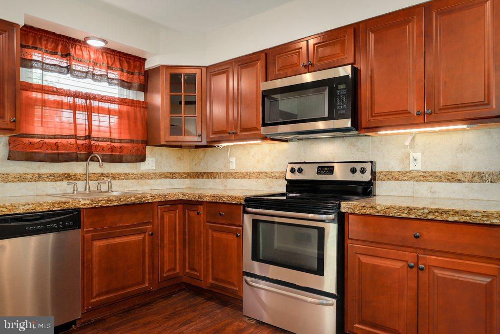 8538 Brest Road Randallstown, MD 21133 - Photo 16 of 47 a kitchen with a sink stove and microwave