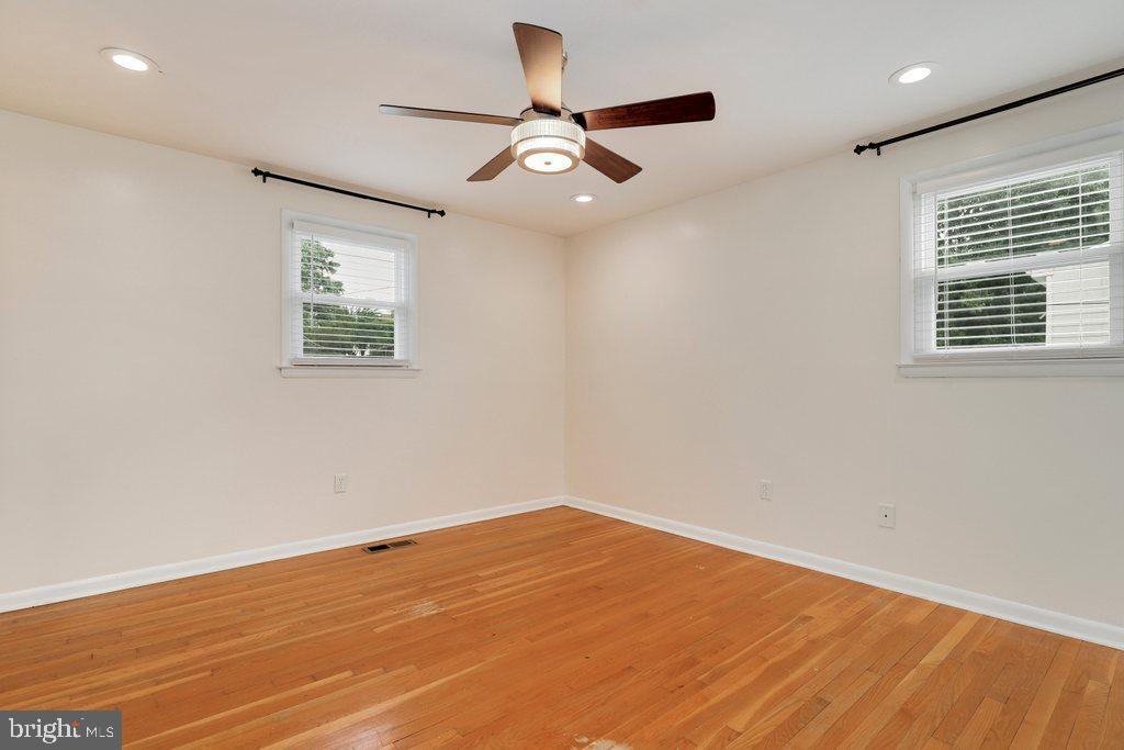 8538 Brest Road Randallstown, MD 21133 - Photo 23 of 47 a view of empty room with wooden floor and fan