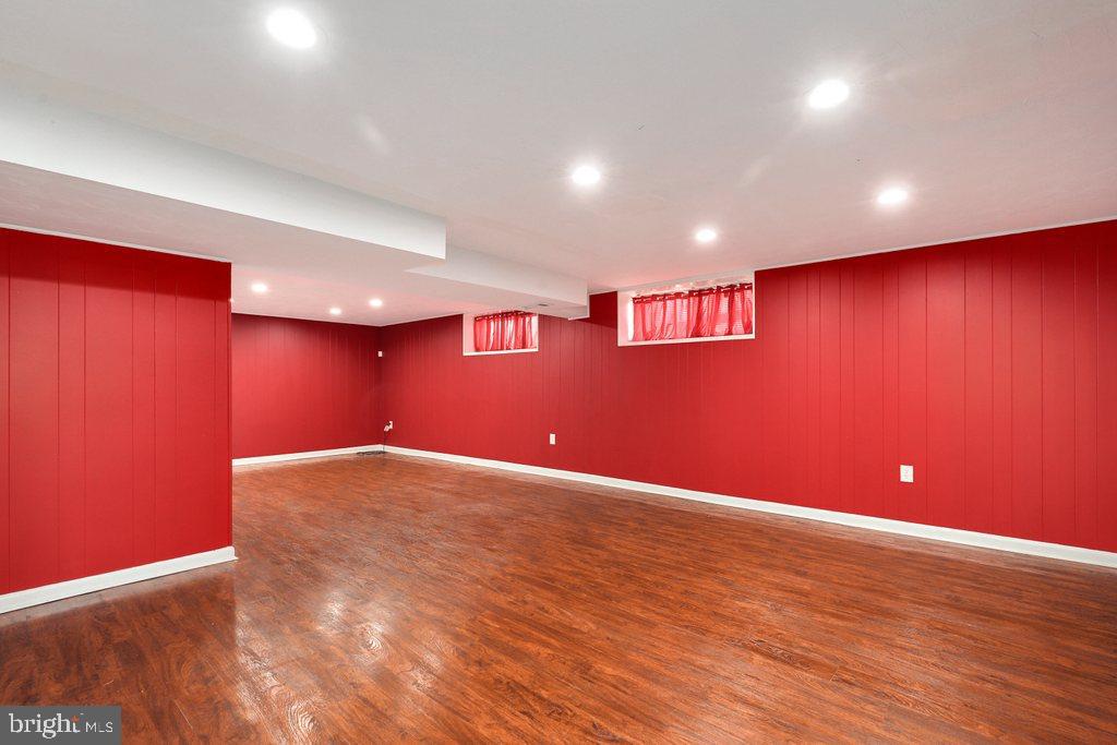 8538 Brest Road Randallstown, MD 21133 - Photo 35 of 47 a view of an empty room with wooden floor and fan