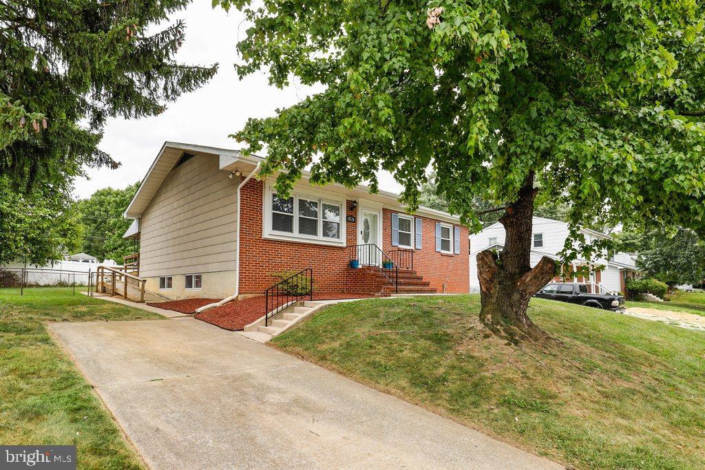 8538 Brest Road Randallstown, MD 21133 - Photo 5 of 47 a front view of a house with a yard and trees