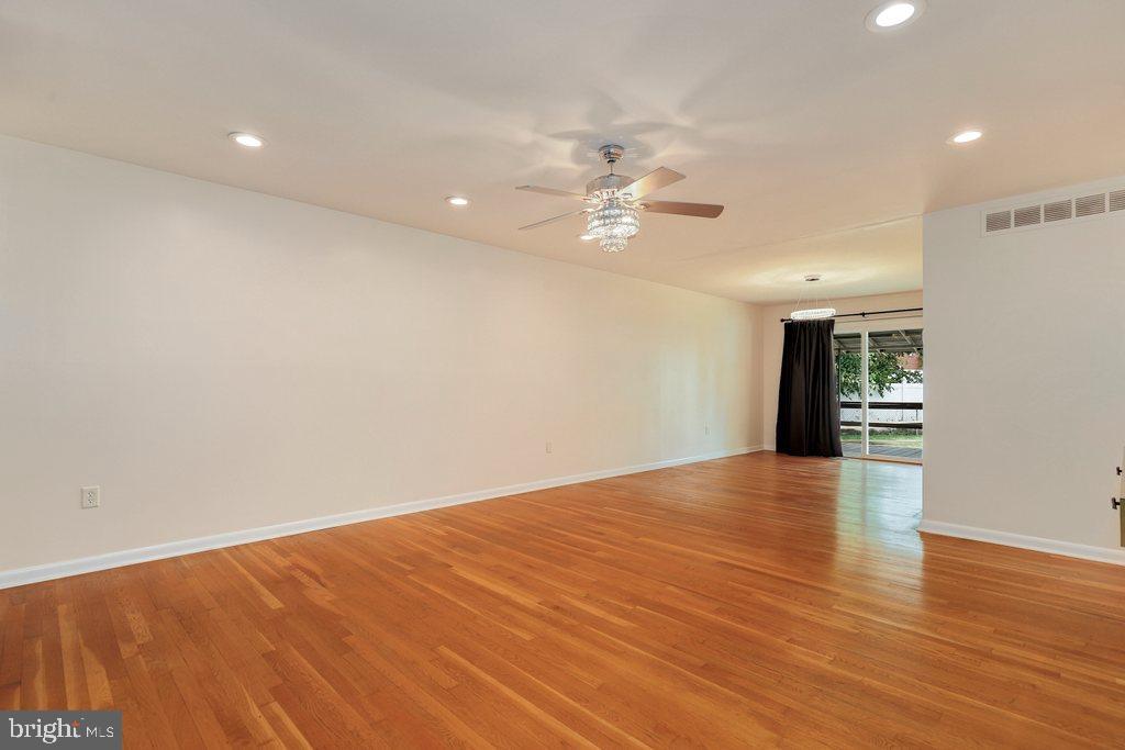 8538 Brest Road Randallstown, MD 21133 - Photo 6 of 47 a view of an empty room with wooden floor
