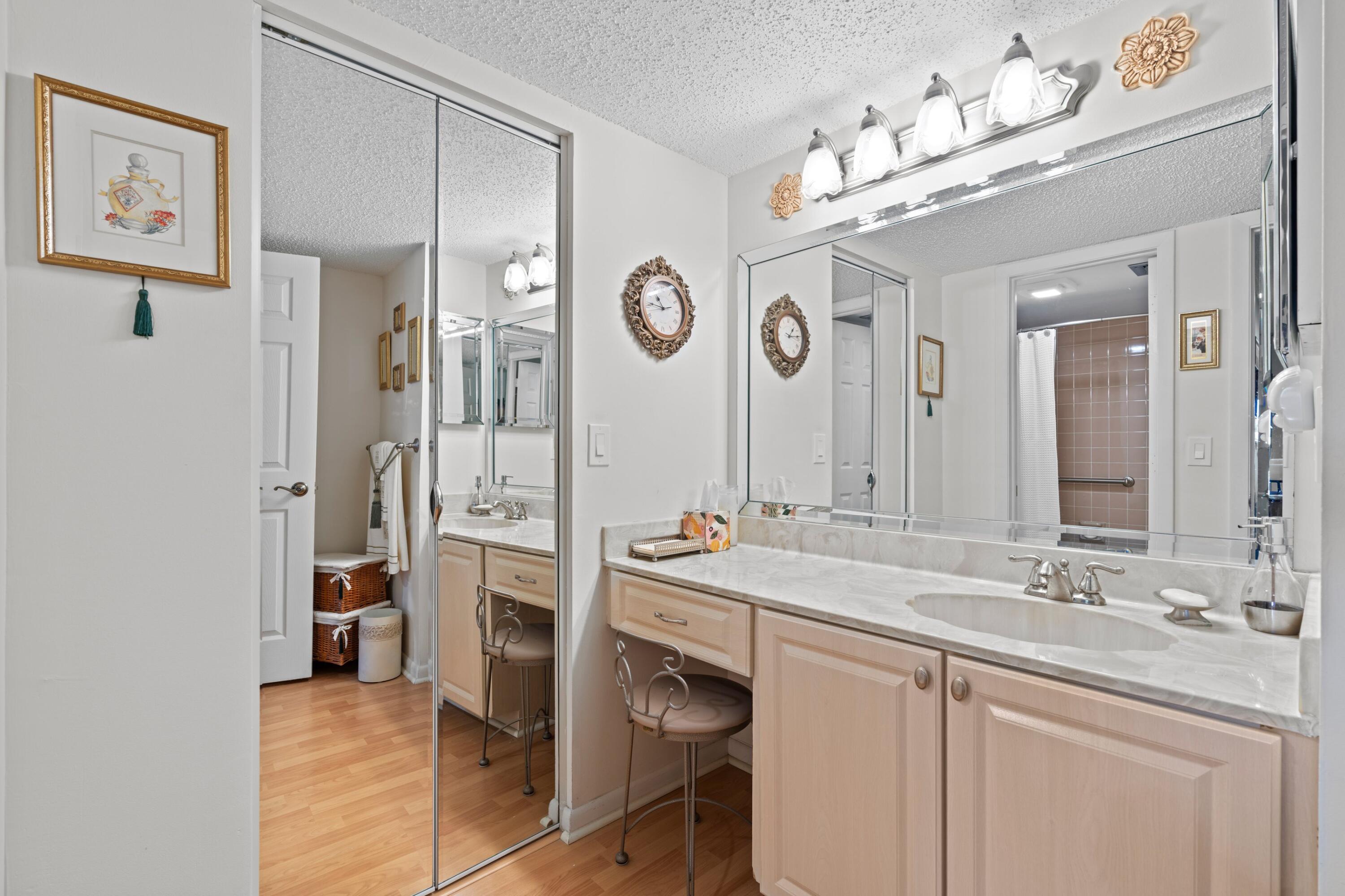 14360 Strathmore Lane, Unit 404 Delray Beach, FL 33446 - Photo 16 of 42 a spacious bathroom with a sink double vanity and a mirror