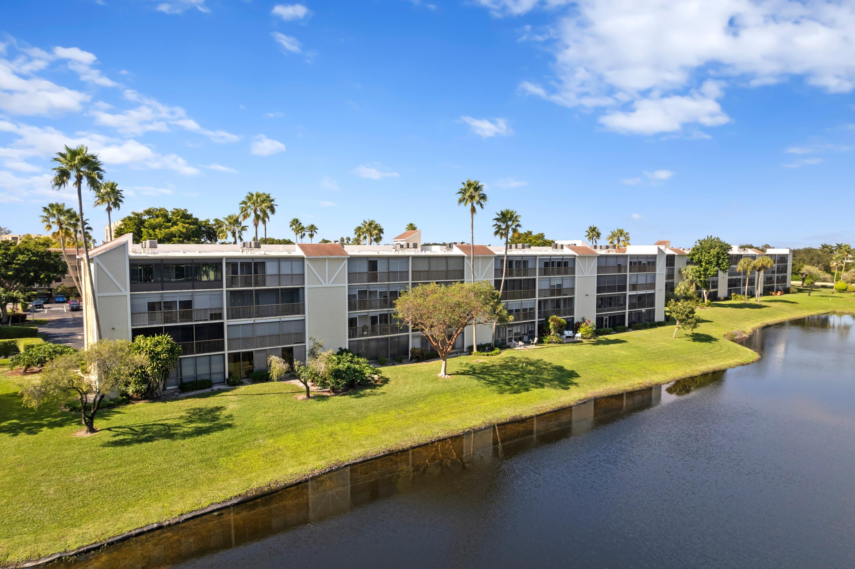 14360 Strathmore Lane, Unit 404 Delray Beach, FL 33446 - Photo 19 of 42 a swimming pool with outdoor seating and yard