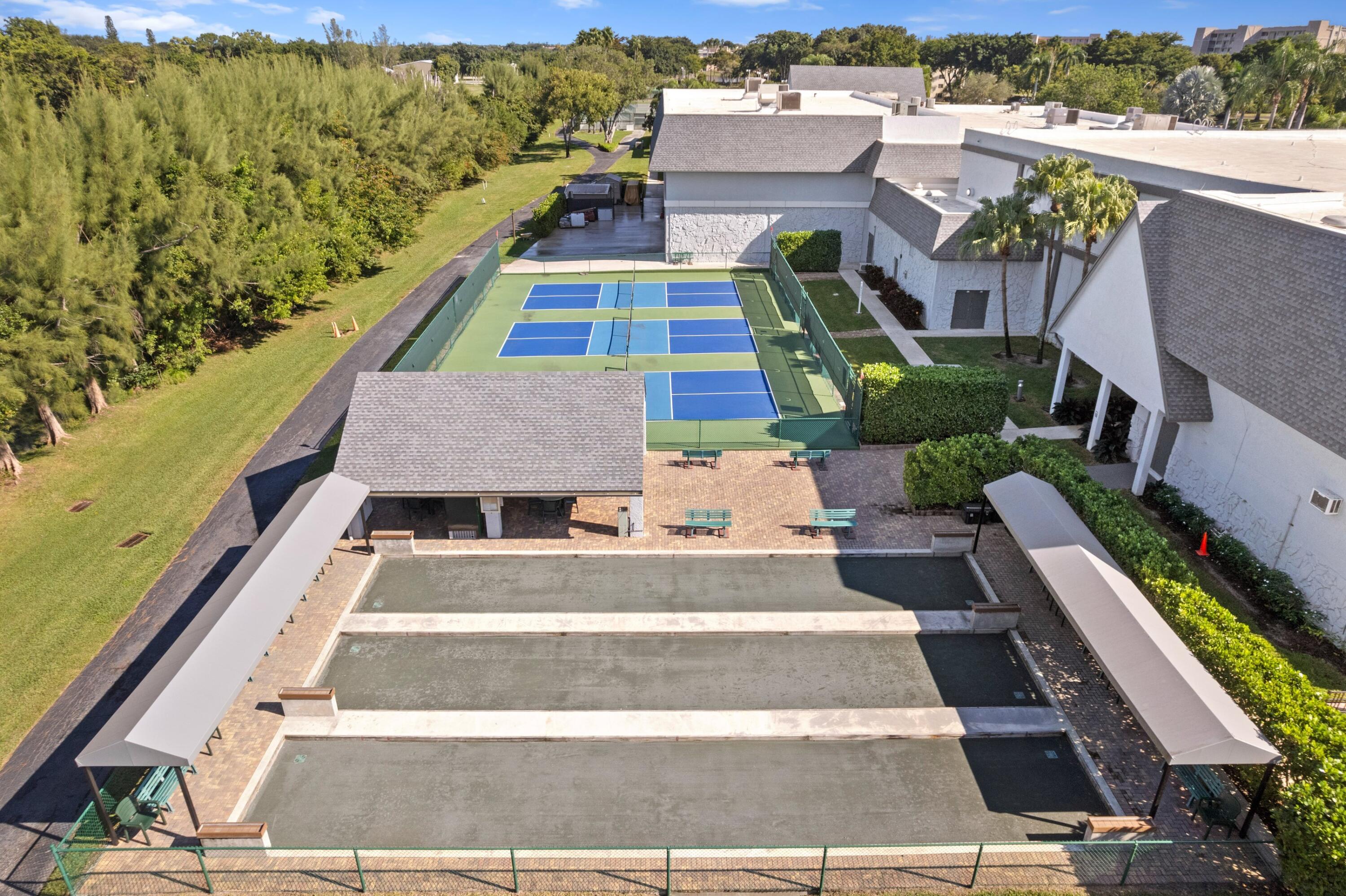 14360 Strathmore Lane, Unit 404 Delray Beach, FL 33446 - Photo 25 of 42 a picture of a building with a garden