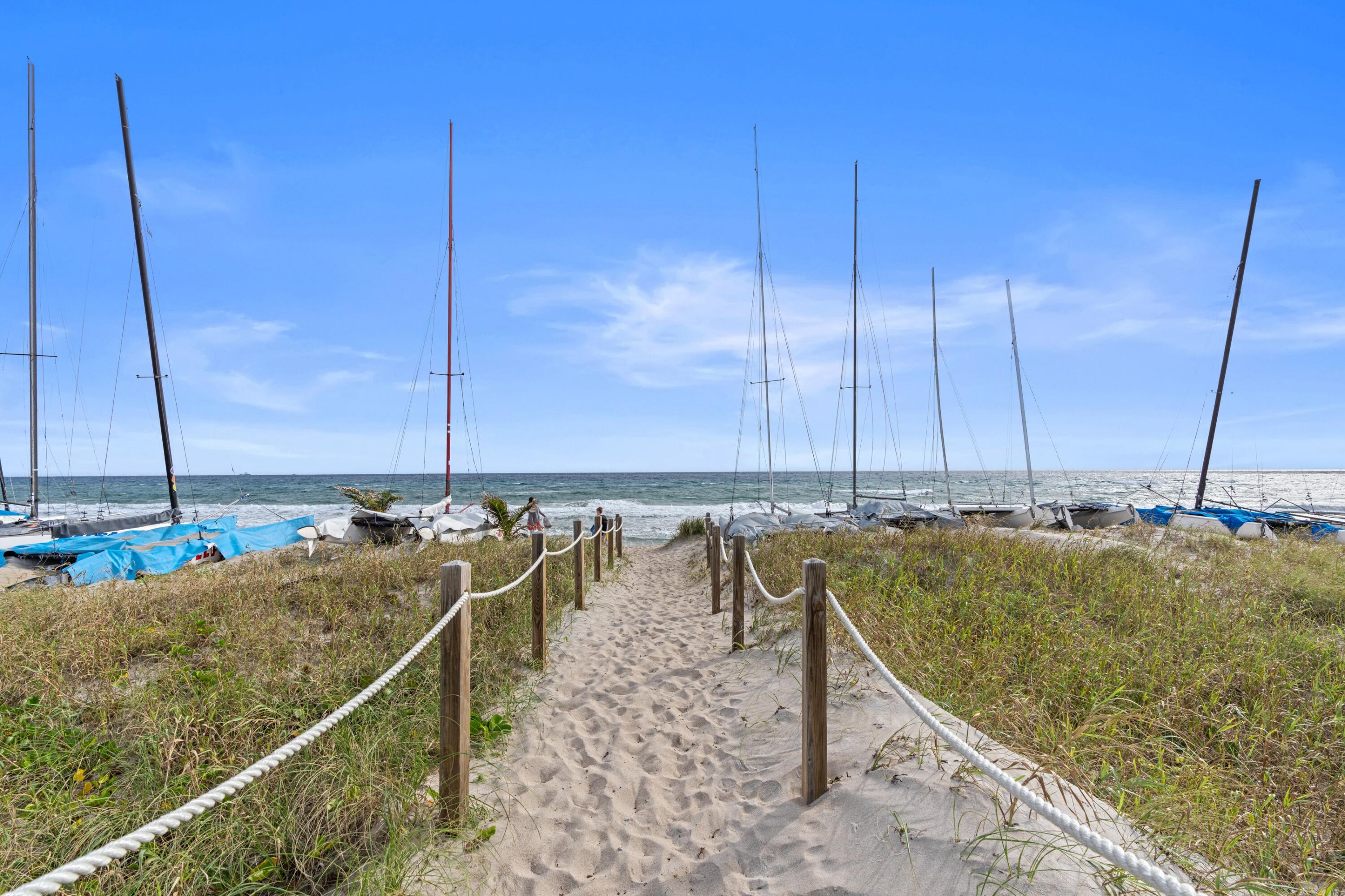 14360 Strathmore Lane, Unit 404 Delray Beach, FL 33446 - Photo 30 of 42 a view of a lake with boats next to a bridge