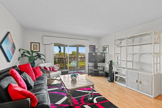 a living room with furniture a rug and gym equipment