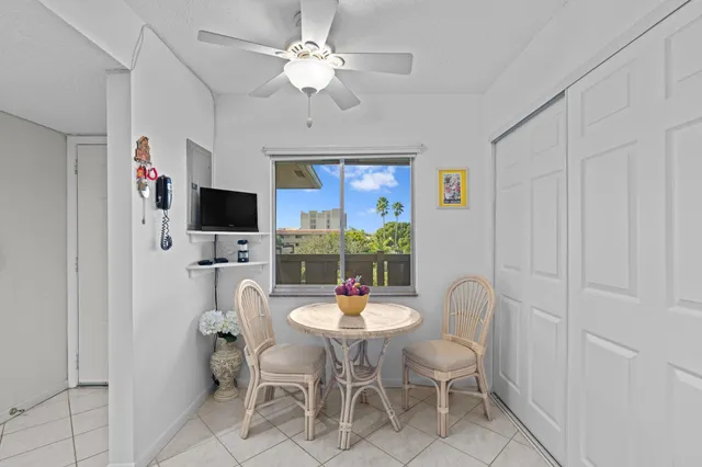a dining room with furniture a chandelier and window