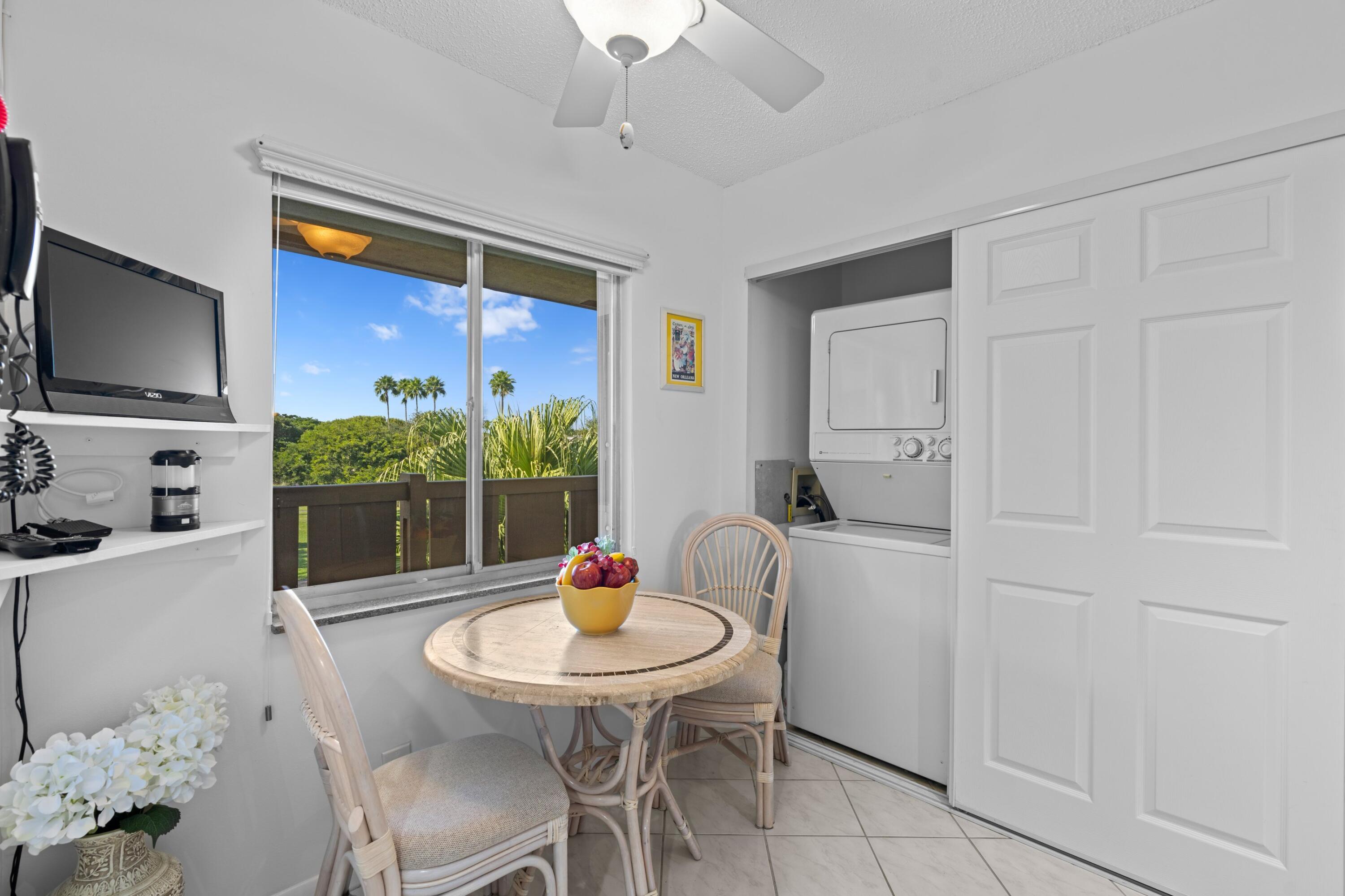 14360 Strathmore Lane, Unit 404 Delray Beach, FL 33446 - Photo 8 of 42 a view of a dining room with furniture and wooden floor