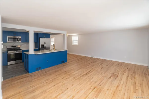 a kitchen with wooden floors and wooden cabinets
