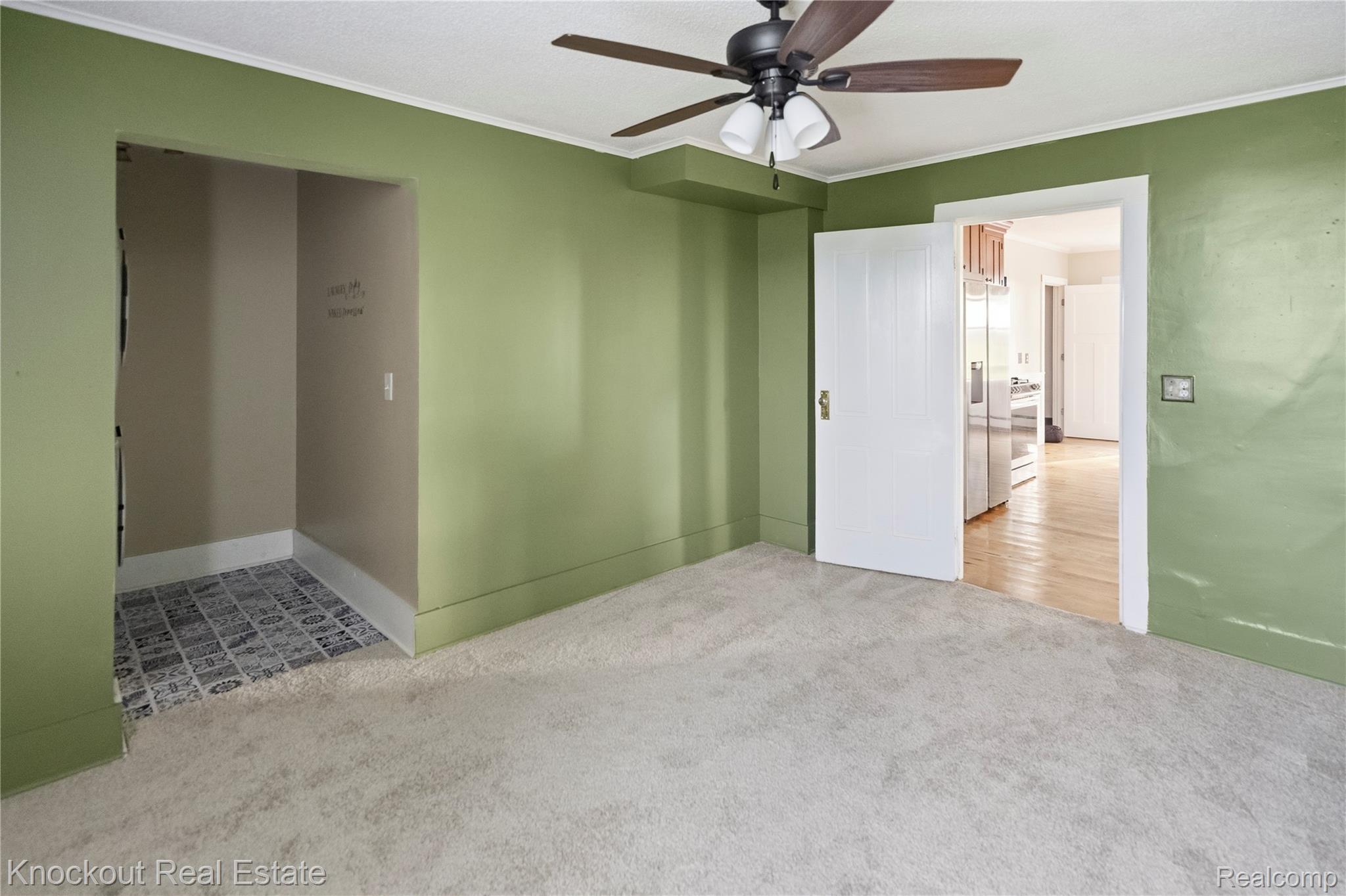 5750 Maple Road Frankenmuth, MI 48734 - Photo 14 of 60 Plush carpet flooring, ceiling fan with light fixture, and an alcove with patterned tile flooring