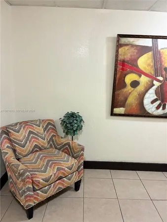 a bedroom with a bed and painting on the wall