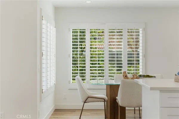 a view of a room with a window and chair