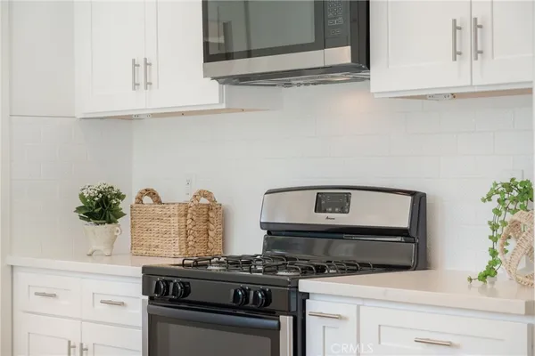a kitchen with stainless steel appliances a stove and cabinets