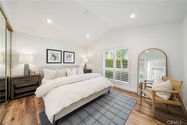 a bedroom with a bed and wooden floor