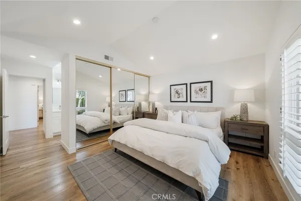 a spacious bedroom with a bed and a couch