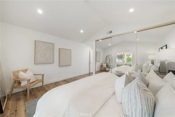 a bedroom with a bed and a chair