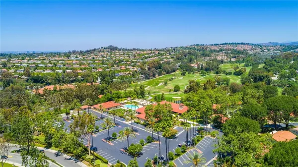an aerial view of residential houses with outdoor space and street view
