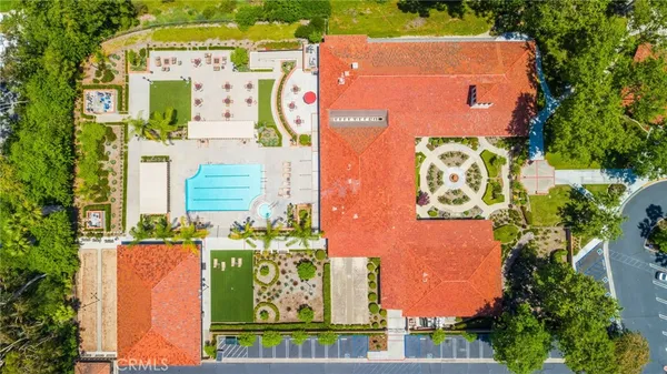 an aerial view of a house with swimming pool garden and lake view