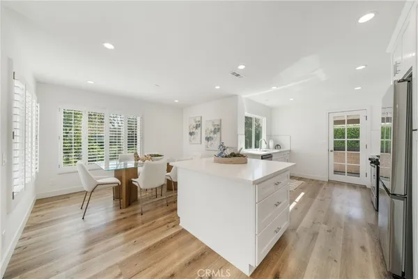 a large white kitchen with a large window