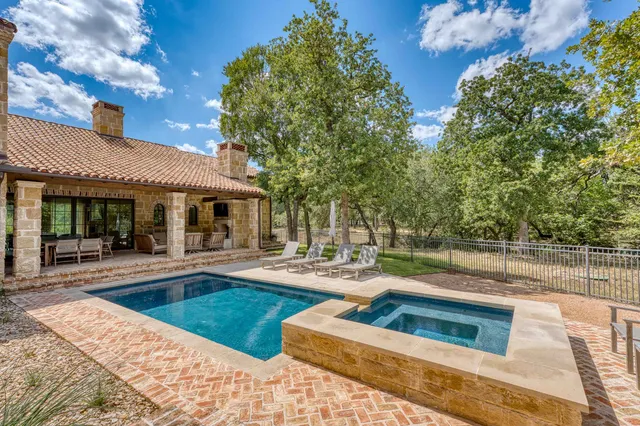 a view of a house with swimming pool and sitting area