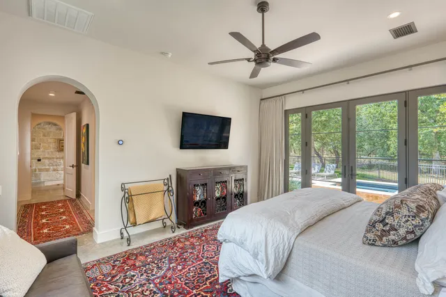 a bedroom with a large bed and a tv