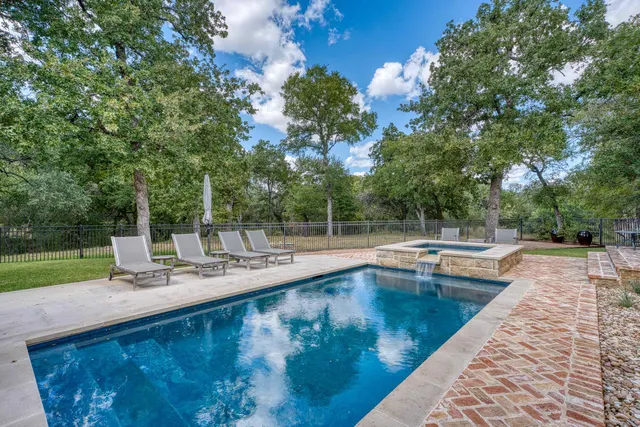 a view of a swimming pool with a patio